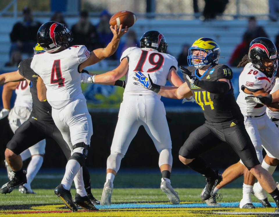 Delaware's Dillon Trainer (44) pressures Saint Francis quarterback Cole Doyle in the second quarter of the opening round of the NCAA FCS tournament at Delaware Stadium, Saturday, Nov. 26, 2022.