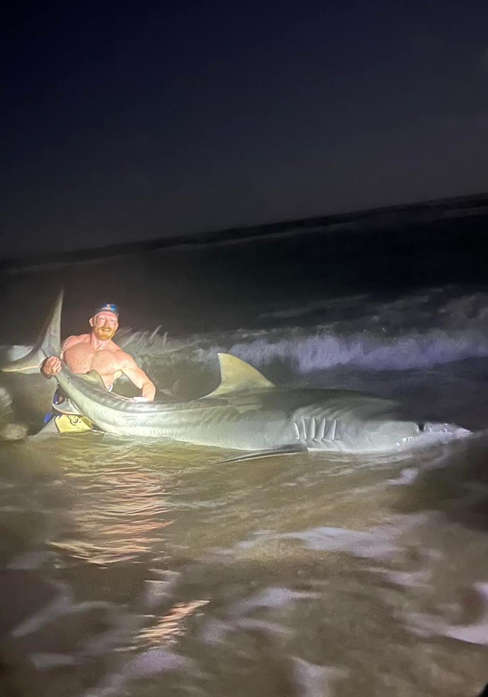 Christian Haltermann reeled in a 12.5-foot tiger shark while fishing at the Padre Island National Seashore with his son in May 2022.