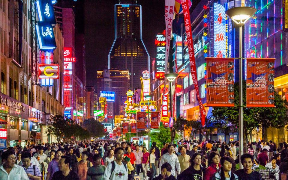 China, Shanghai, nightview of Nanjing Road pedestrian zone, one of the world's busiest shopping streets - Manfred Gottschalk /Getty Images Contributor 