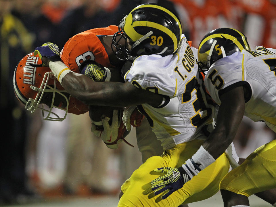 CHAMPAIGN, IL - NOVEMBER 12: Jon Davis #3 of the Illinois Fighting Illini is hit by Thomas Gordon #30 and Courtney Avery #5 of the Michigan Wolverines at Memorial Stadium on November 12, 2011 in Champaign, Illinois. Michigan defeated Illinois 31-14. (Photo by Jonathan Daniel/Getty Images)