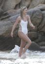 <p>Wearing a white strappy <a rel="nofollow noopener" href="http://www.neimanmarcus.com/en-gb/Ale-by-Alessandra-Free-Spirit-Lace-Back-Strappy-Maillot-Swimsuit-White-ale-by-alessandra/prod197110003___/p.prod?icid=&searchType=MAIN&rte=%252FeSearch.jsp%253FN%253D0%2526Ntt%253Dale%252Bby%252Balessandra%2526from%253DbrSearchExcep%2526_requestid%253D41333&eItemId=prod197110003&cmCat=search" target="_blank" data-ylk="slk:Ale by Alessandra;elm:context_link;itc:0;sec:content-canvas" class="link ">Ale by Alessandra</a> swimsuit.<br><i>[Photo: FameFlynet]</i> </p>