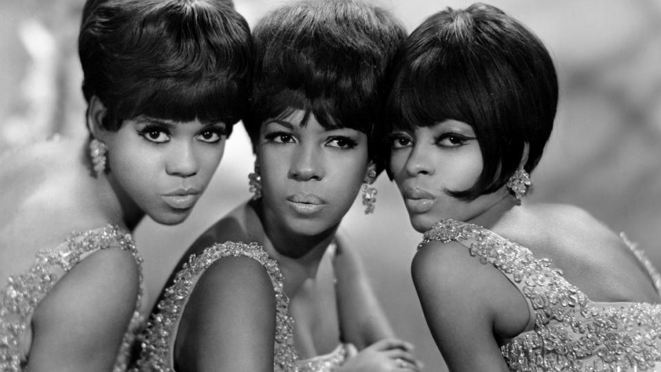 close up of the supremes wearing matching glittering outfits and earrings