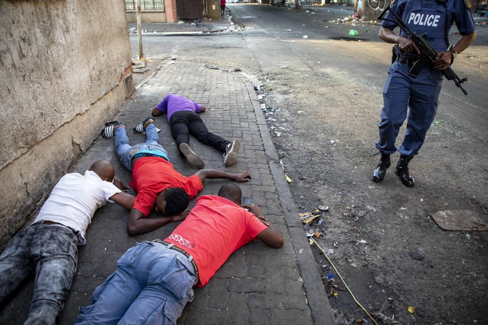 People lay on the ground after being arrested in Jeppe's Town, Johannesburg, Tuesday, Sept. 3, 2019. Police have struggled to stop looters who have been targeting businesses as unrest broke out in several spots in and around the city. (AP Photo)