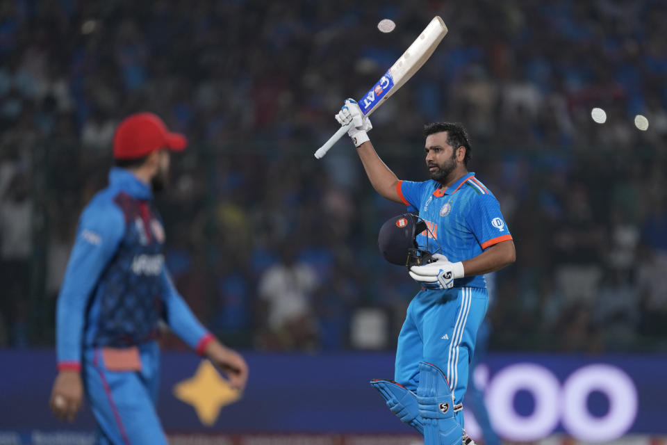 India's captain Rohit Sharma celebrates his century during the ICC Men's Cricket World Cup match between Afghanistan and India in New Delhi, India, Wednesday, Oct. 11, 2023. (AP Photo/Manish Swarup)