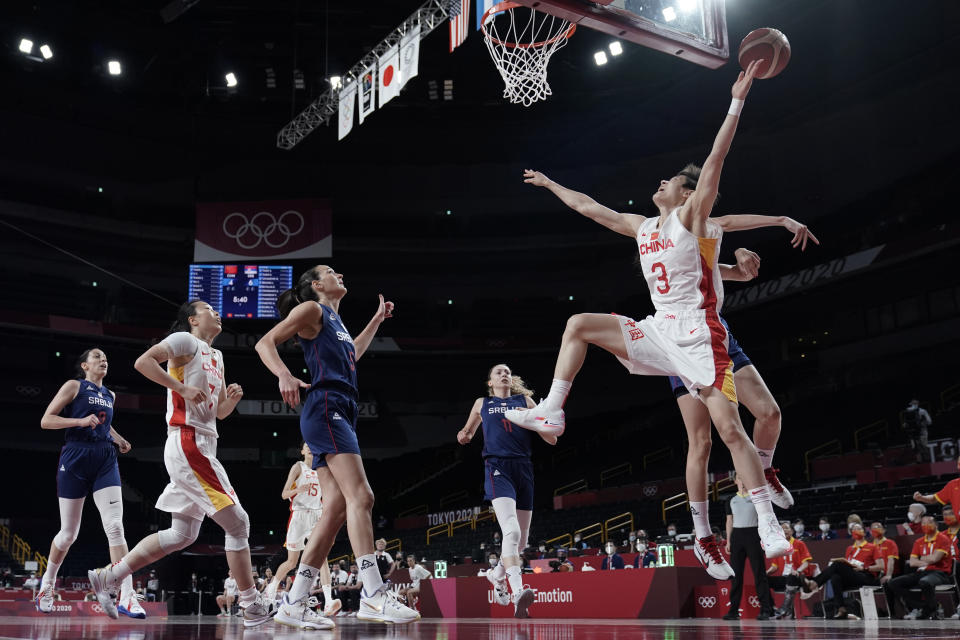 China's Liwei Yang (3) is fouled as she drives to the basket against Serbia during a women's basketball quarterfinal game at the 2020 Summer Olympics, Wednesday, Aug. 4, 2021, in Saitama, Japan. (AP Photo/Eric Gay)
