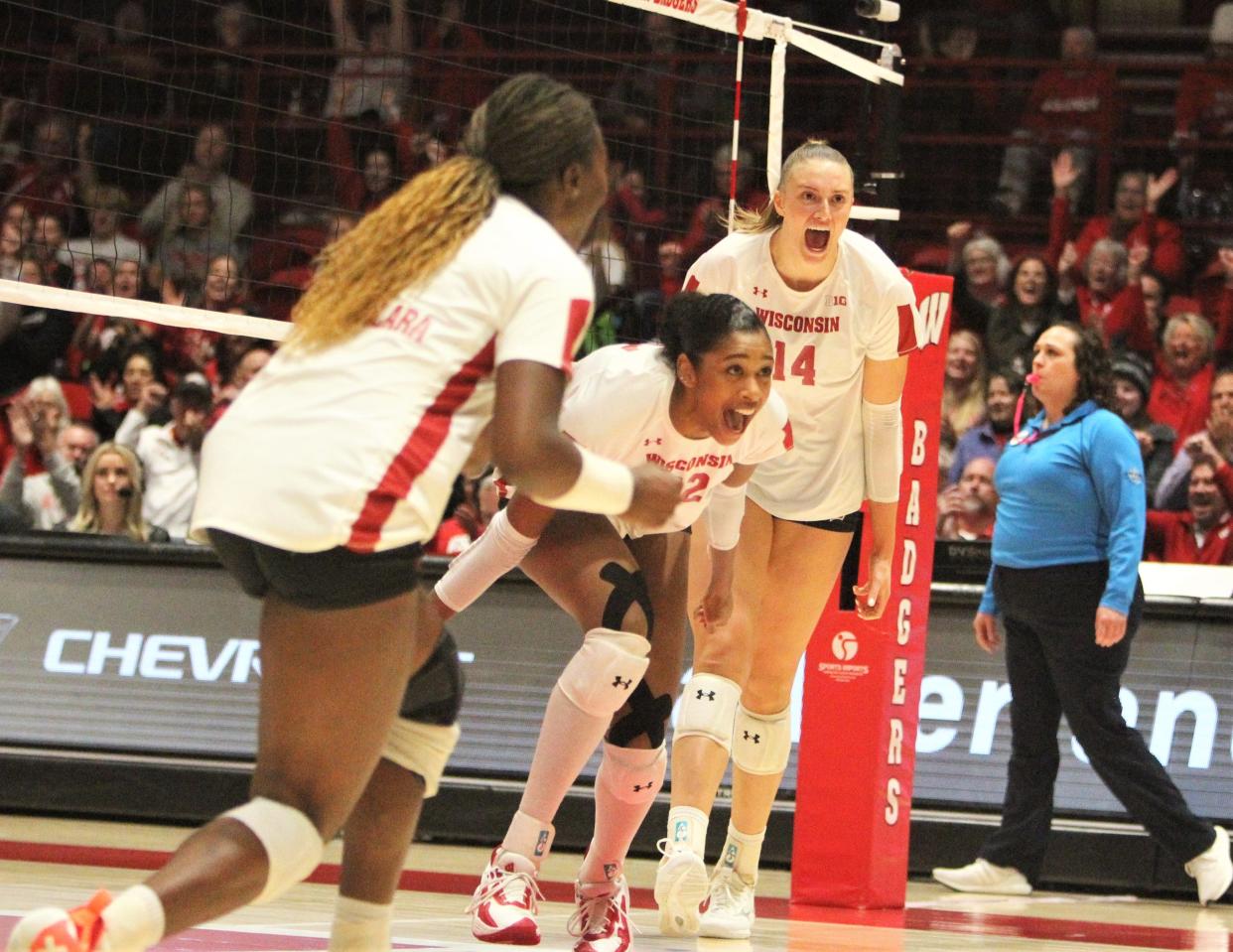 Wisconsin middle blocker Carter Booth (center) celebrates with Anna Smrek (14) and Temi Thomas-Ailara during a match with Minnesota on Sunday Oct. 29, 2023 at the UW Field House in Madison, Wisconsin.