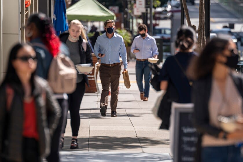 Workers carry lunch to go on 2nd Street in San Francisco, California, U.S., on Tuesday, Oct. 5, 2021. About 21% of San Francisco areas office workers had returned as of Sept. 22, according to Kastle Systemsa figure that is little changed since the summer and the lowest among 10 U.S. metro areas. Photographer: David Paul Morris/Bloomberg via Getty Images