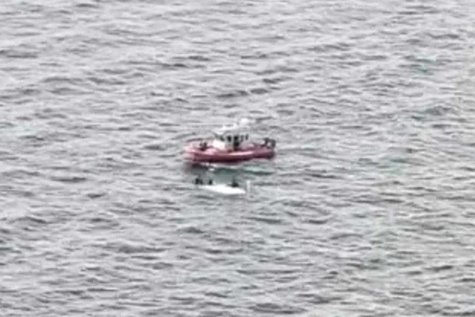 <p>U.S. Coast Guard District 7</p> The U.S. Coast Guard attends the upturned boat near Florida