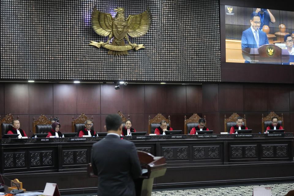 Judges listen as losing presidential candidate Anies Baswedan speaks at the start of the first hearing of his legal challenge to the Feb. 14 presidential election alleging widespread fraud, at the Constitutional Court in Jakarta, Indonesia, Wednesday, March 27, 2024. Defense Minister Prabowo Subianto, who chose the son of the popular outgoing President Joko Widodo as his running mate, won the election by 58.6% of the votes, according to final results released by the Election Commission. (AP Photo/Dita Alangkara)