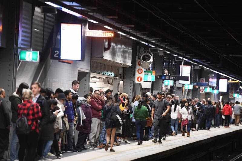 Commuters are seen at Town Hall train station in Sydney.