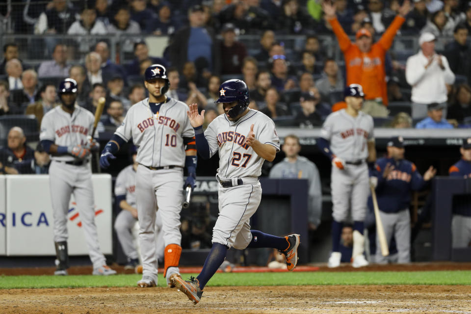 Houston Astros' Jose Altuve celebrates after scoring on a wild pitch during the seventh inning in Game 3 of baseball's American League Championship Series against the New York Yankees Tuesday, Oct. 15, 2019, in New York. (AP Photo/Matt Slocum)