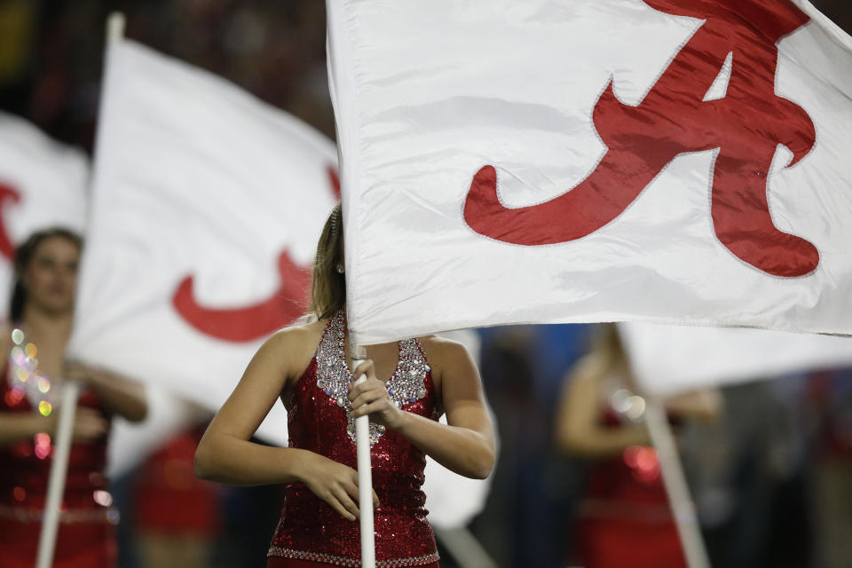 Alabama's flag team perform with the band before the first half of the Southeastern Conference championship NCAA college football game between Alabama and Missouri, Saturday, Dec. 6, 2014, in Atlanta. (AP Photo/Brynn Anderson)