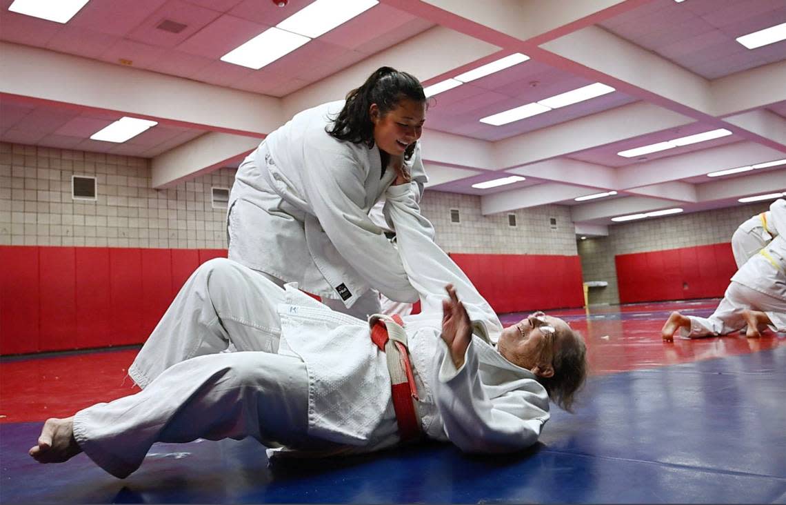 Eighty-three year old Myra Kirk-Goode is gently thrown to the floor by Cassandra Asanuma in Myra’s judo class Wednesday, April 17, 2024 in Clovis