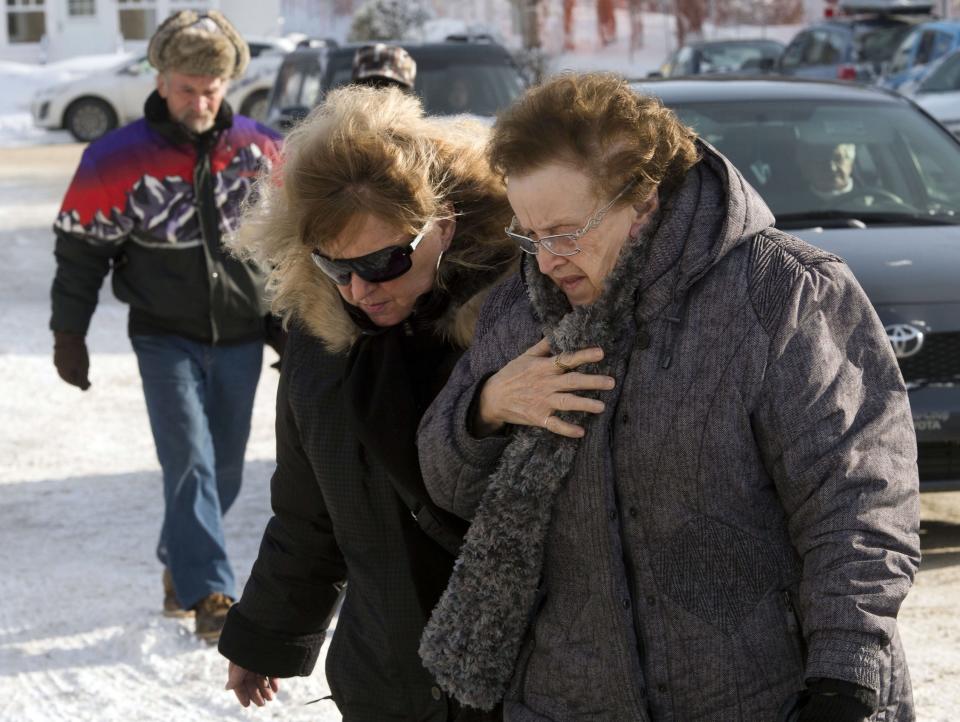 People arrive for a commemorative service for victims of last week's fatal fire at a seniors residence, Sunday, Jan. 26, 2014, in L'Isle-Verte, Quebec. (AP Photo/The Canadian Press, Ryan Remiorz)