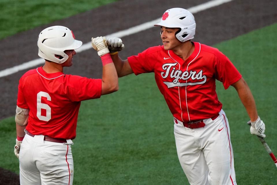 Beechwood’s Cameron Boyd, right, is congratulated after hitting an inside-the-park home run in the fourth inning during the Kentucky Ninth Region championship game, Wednesday, May 24, 2023, at Thomas More Stadium in Florence, Ky. Cameron Boyd