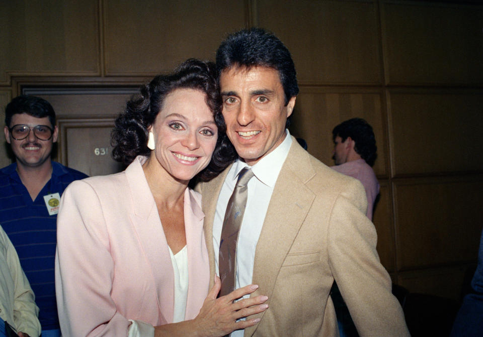 FILE - In this Sept. 16, 1988 file photo, Actress Valerie Harper, left, and her husband, Tony Cacciotti, hug and smile after a jury decided in her favor against Lorimar Telepictures Corp. in a dispute that ended her role in the "Valerie" television series, in Los Angeles. Valerie Harper, who scored guffaws and stole hearts as Rhoda Morgenstern on back-to-back hit sitcoms in the 1970s, has died, Friday, Aug. 30, 2019. She was 80. (AP Photo/Nick Ut, File)