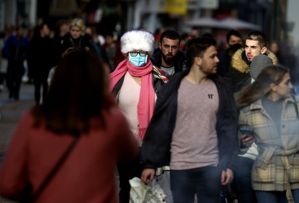 Christmas shoppers in Oxford city centre England, Sunday Dec. 20, 2020. (Steve Parsons/PA via AP)