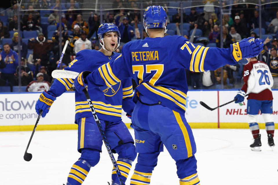 Buffalo Sabres right wing JJ Peterka (77) celebrates his goal with center Dylan Cozens (24) during the first period of an NHL hockey game against the Colorado Avalanche, Thursday, Dec. 1, 2022, in Buffalo, N.Y. (AP Photo/Jeffrey T. Barnes)