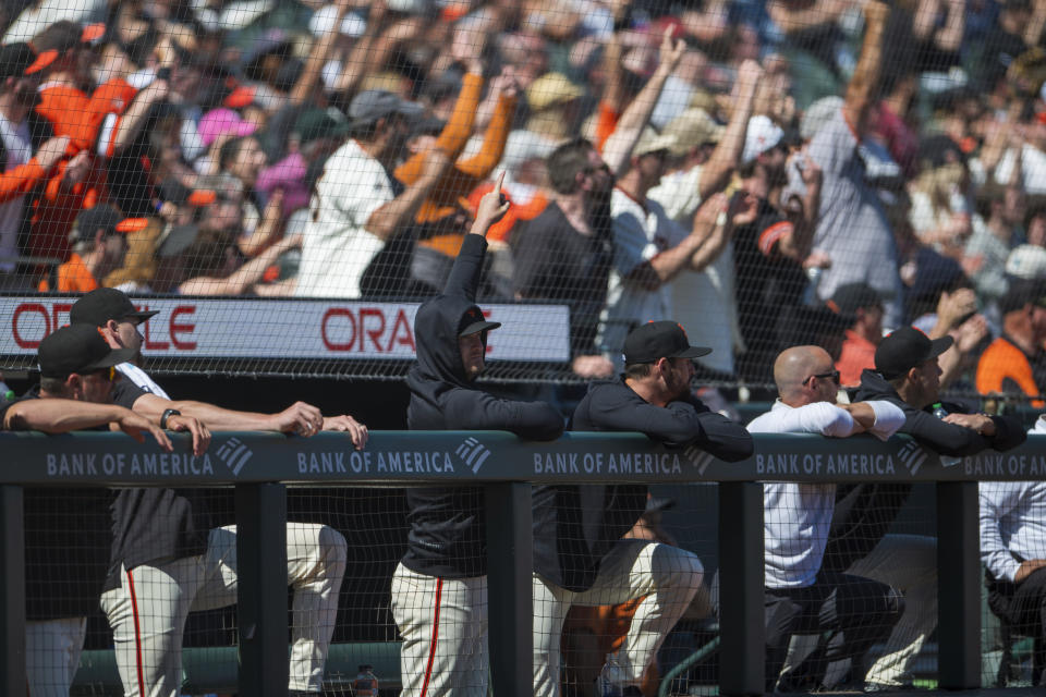 San Francisco Giants fans and players react after a double by Giants' Patrick Bailey during the seventh inning of a baseball game against the Arizona Diamondbacks, Saturday, April 20, 2024, in San Francisco. (AP Photo/Nic Coury)