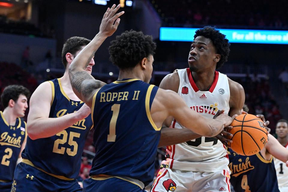 Feb 21, 2024; Louisville, Kentucky, USA; Notre Dame Fighting Irish guard Julian Roper II (1) defends Louisville Cardinals forward Emmanuel Okorafor (34)