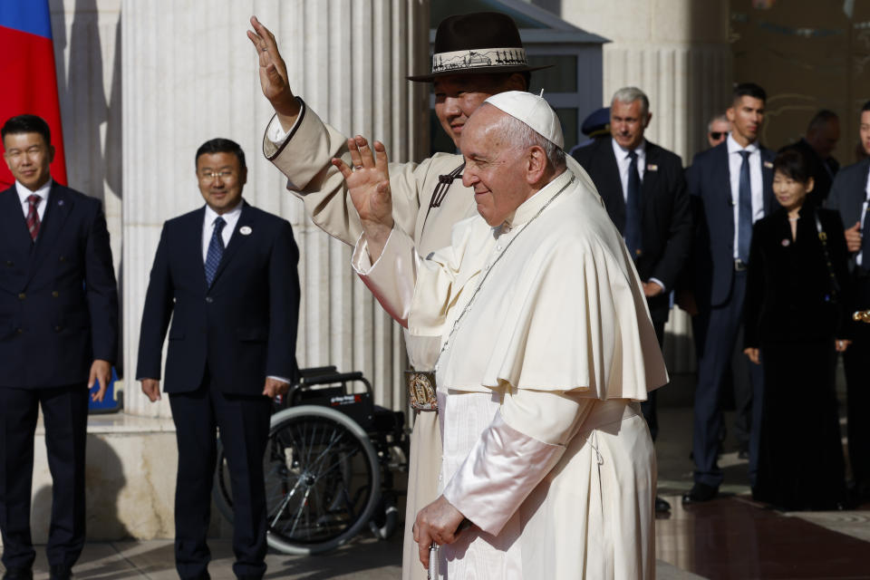 Mongolian President Ukhnaagin Khurelsukh, left, wave with Pope Francis, Saturday, Sept. 2, 2023, at the Saaral Ordon State Palace in Sukhbaatar Square in Ulaanbaatar. Pope Francis arrived in Mongolia on Friday morning for a four-day visit to encourage one of the world's smallest and newest Catholic communities. (AP Photo/Remo Casilli, pool)