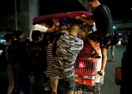 Commuters push their way in to a jeepney in Cubao, Quezon City, Philippines, December 3, 2018. REUTERS/Eloisa Lopez