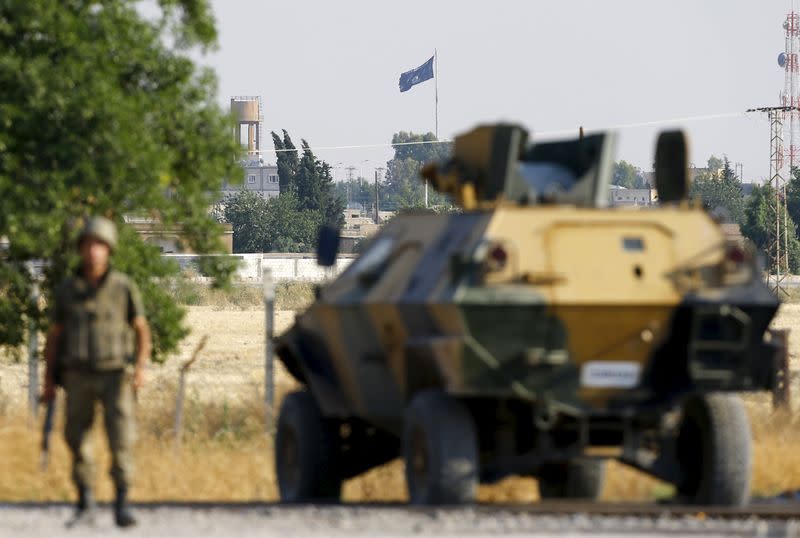 An  Islamic State flag flies in the northern Syrian town of Tel Abyad as it is pictured from the Turkish border town of Akcakale, in Sanliurfa province, Turkey, June 15, 2015. REUTERS/Umit Bektas 