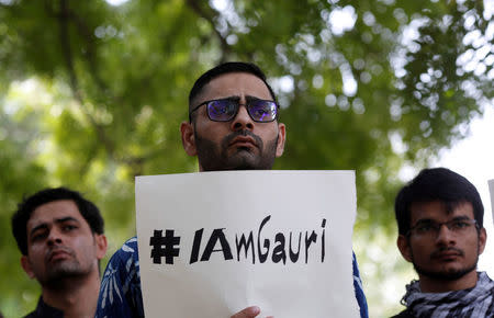 FILE PHOTO: A protester holds a placard during a protest rally against the killing of Gauri Lankesh, an Indian journalist, in New Delhi, India, September 6, 2017. REUTERS/Adnan Abidi/File Photo