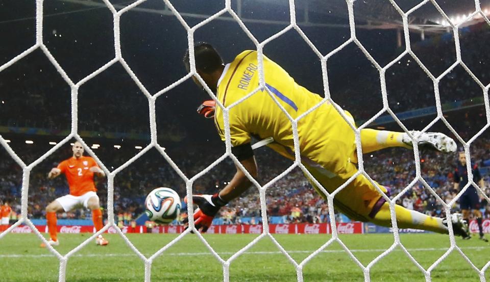 Argentina's Romero saves the penalty of Vlaar of the Netherlands during their shootout in their 2014 World Cup semi-finals at the Corinthians arena in Sao Paulo