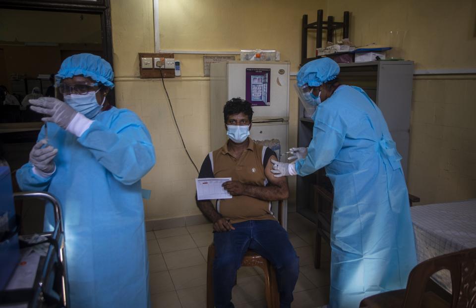 A Sri Lankan man receives a dose of Sinopharm vaccine for COVID-19 in Colombo, Sri Lanka, Saturday, May 8, 2021. Sri Lanka's highest medicines regulatory body approved the emergency use of China's Sinopharm to curb the spread of coronavirus in the country. (AP Photo/Eranga Jayawardena)
