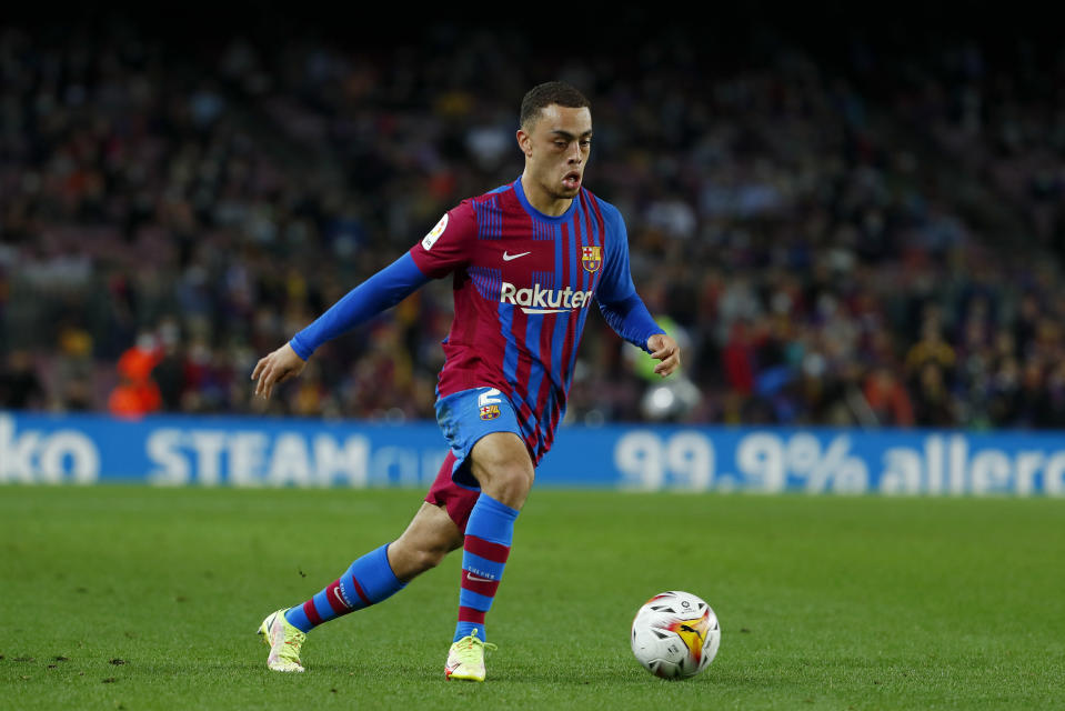 Barcelona's Sergino Dest runs with the ball during the La Liga soccer match between Barcelona and Alaves at the Camp Nou stadium in Barcelona, Spain Saturday, Oct. 30, 2021. (AP Photo/Joan Monfort)