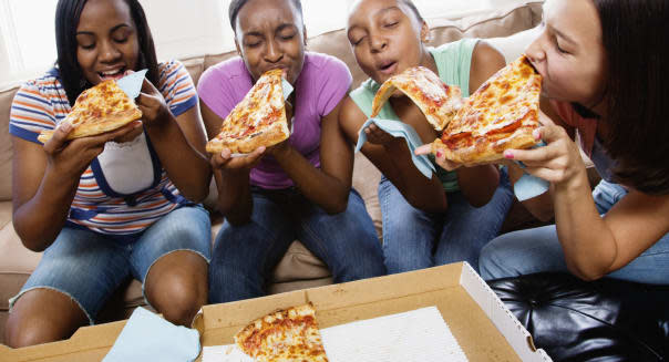 Five Teenagers Eating Pizza