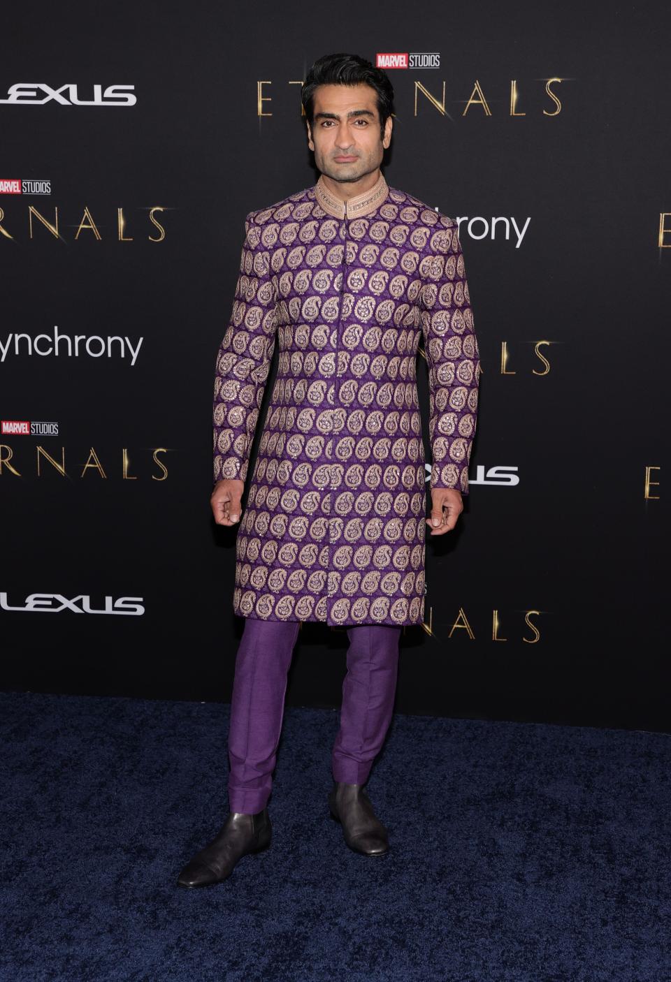 Kumail Nanjiani in a purple jacket and pants