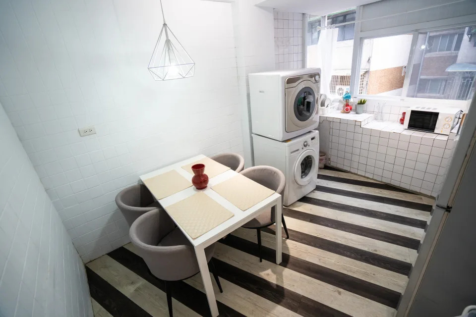 High angle view of interior of dining room and kitchen with washing machine