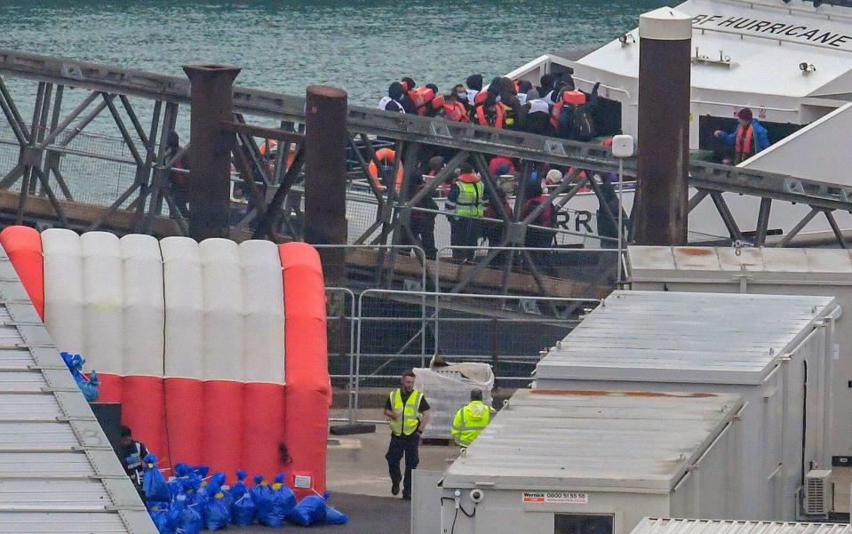 People believed to be migrants disembark from a British Border Force vessel after being picked up in the English Channel and brought to Dover last month - Stuart Brock/Shutterstock