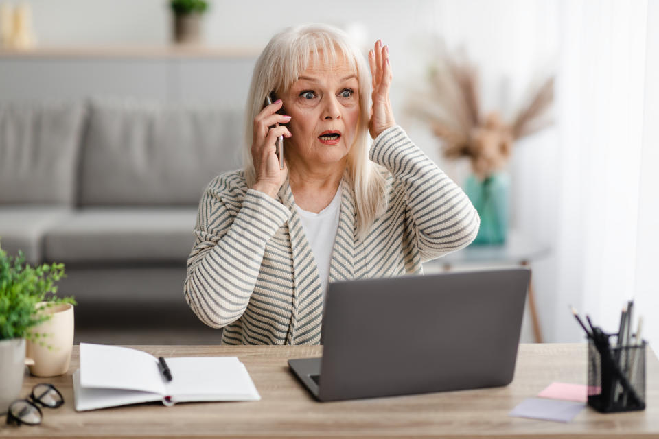 Shocked mature woman talking on smartphone. Source: Getty Images