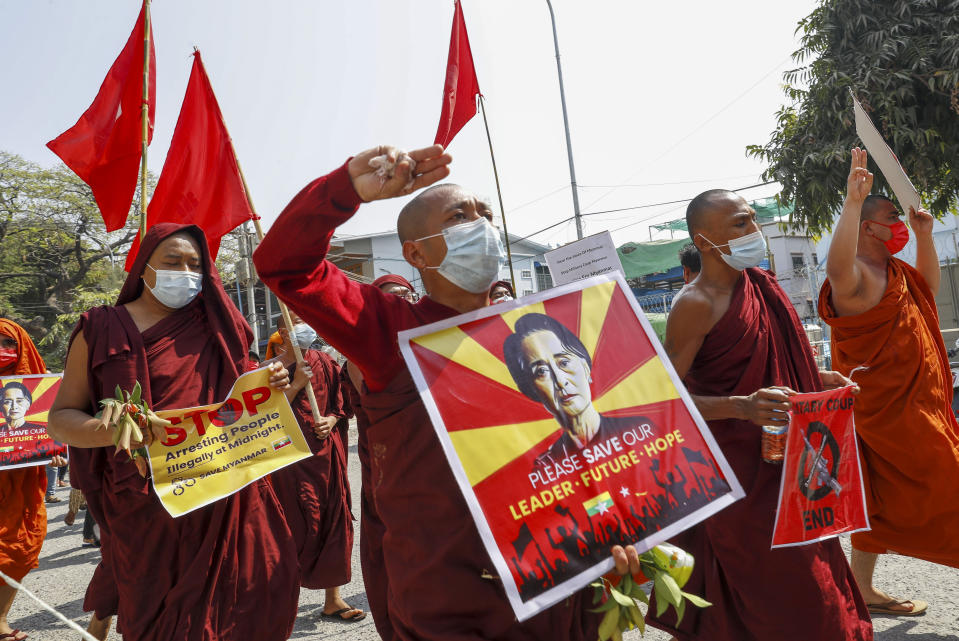 Buddhist monks and nuns display pictures of detained Myanmar leader Aung San Suu Kyi during a protest against the military coup in Mandalay, Myanmar on Tuesday, Feb. 16, 2021. Peaceful demonstrations against Myanmar’s military takeover resumed Tuesday, following violence against protesters a day earlier by security forces and after internet access was blocked for a second straight night. (AP Photo)