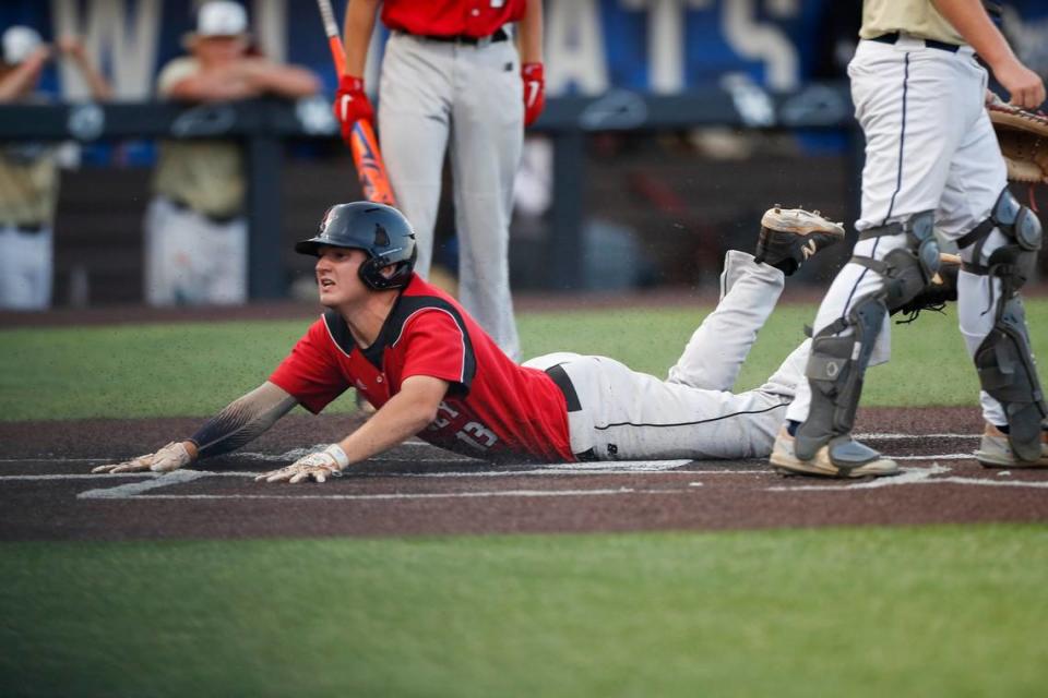 Whitley County’s Sam Harp (13) slides into home plate on a steal to score a run against Shelby County during the state championship game at Kentucky Proud Park on Saturday.