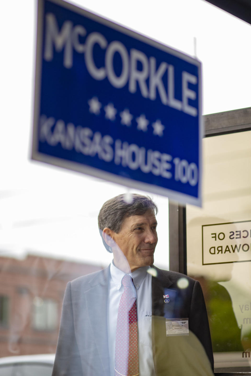 Mike McCorkle holds the door for an attendee of a May 4, 2024, meet-and-greet fundraiser for his campaign.