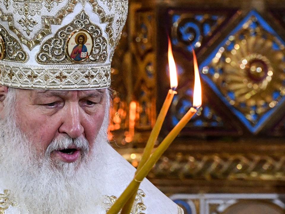 Russian Patriarch Kirill holds two lit candles