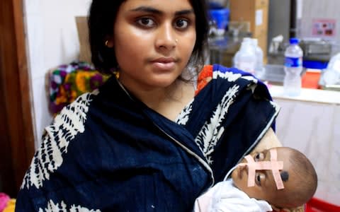 Baby Sammiya being held by her mother at the International Centre for Diarrhoeal Disease Research, Bangladesh - Credit: Susannah Savage