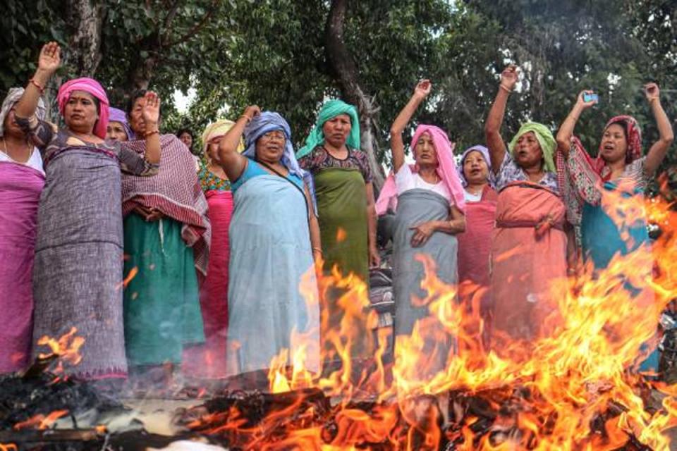Protesters shout slogans as they burn effigies of prime minister Narendra Modi, federal home minister Amit Shah and Manipur chief minister N Biren Singh during a demonstration in Imphal on 8 September 2023 (AFP via Getty Images)
