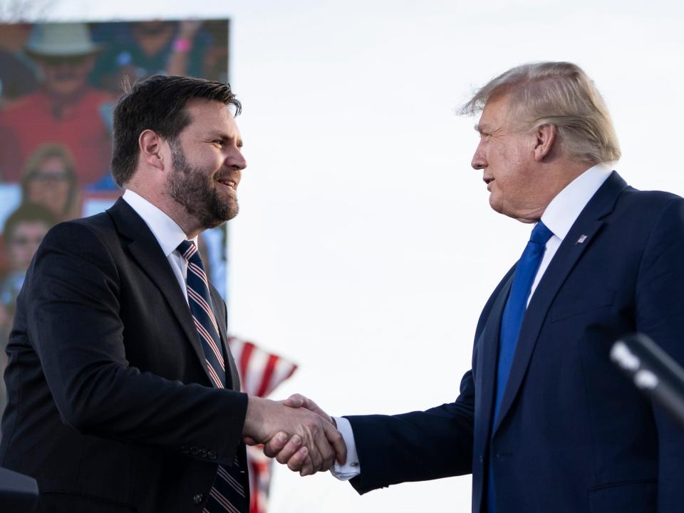 JD Vance and former President Donald Trump shake hands in 2022.