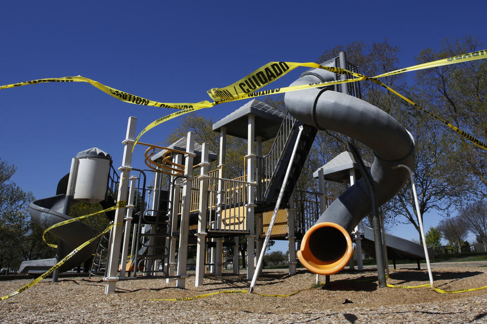 FILE - In this April 2, 2020, file photo, caution tape surrounds the playground at Country Side Community Park in Elk Grove, Calif. (AP Photo/Rich Pedroncelli, File)