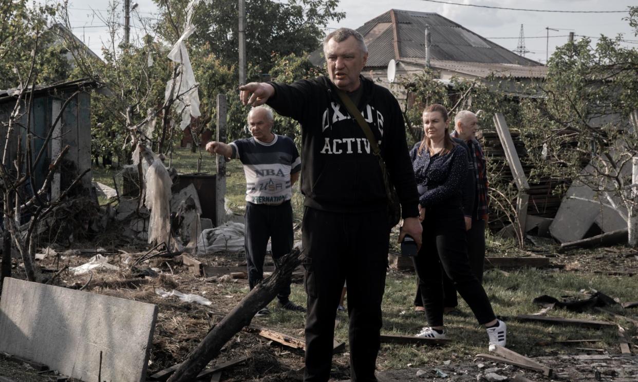 <span>Neighbours point to the site of a rocket attack in the northern part of Kharkiv on Saturday.</span><span>Photograph: Jędrzej Nowicki/The Guardian</span>