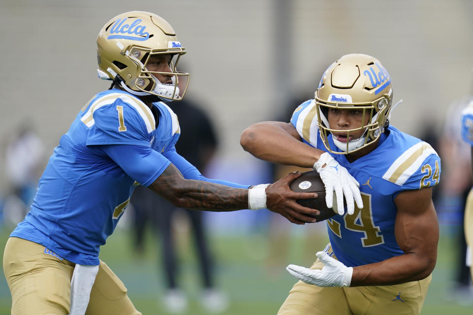 UCLA quarterback Dorian Thompson-Robinson (1) hands off the running back Zach Charbonnet (24) during an NCAA college football game against Alabama State in Pasadena, Calif., Saturday, Sept. 10, 2022. (AP Photo/Ashley Landis)