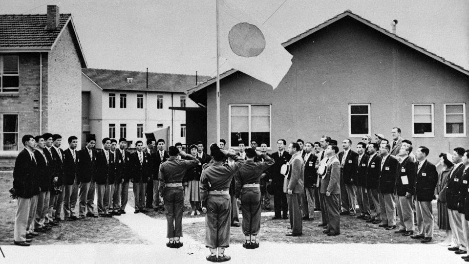 The Japan delegation attend the athlete village entering ceremony ahead of the 1956 Melbourne Olympic Games in Australia. - The Asahi Shimbun/Getty Images