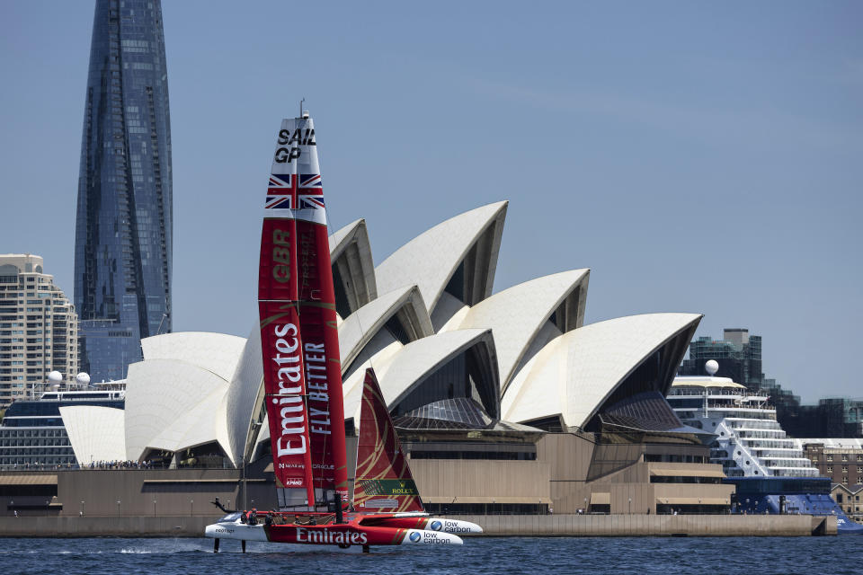 In a photo provided by SailGP, the Emirates Great Britain SailGP Team, helmed by Ben Ainslie, sails past the Sydney Opera House during a practice session on the first day of sailing ahead of the Australia Sail Grand Prix in Sydney, Australia. Thursday, Feb. 16, 2023. (Simon Bruty/SailGP via AP)