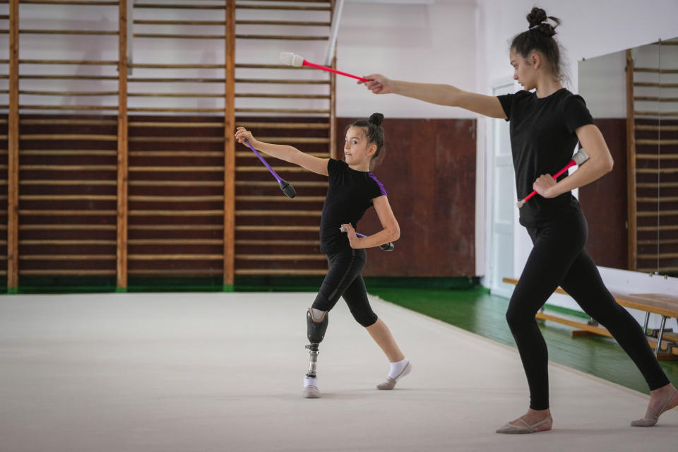 Oleksandra Paskal, an 8-year-old girl with a prosthetic leg, practices rhythmic gymnastics with other girls in Chornomorsk, Odesa region, Ukraine, Thursday, May 16, 2024. (AP Photo/Efrem Lukatsky)