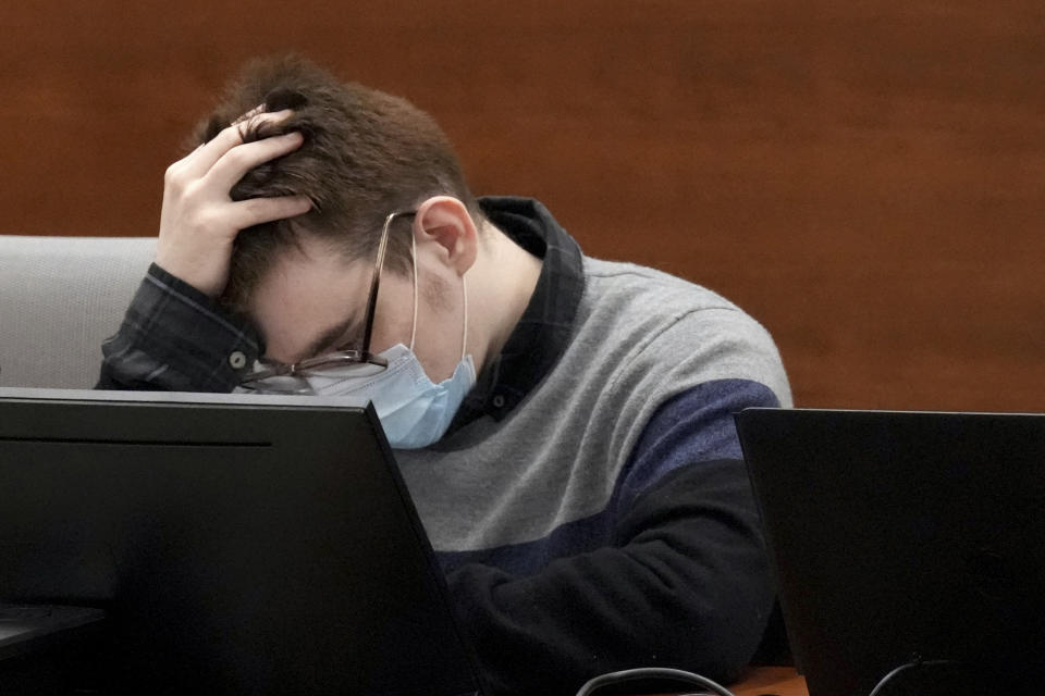 Marjory Stoneman Douglas High School shooter Nikolas Cruz holds his head in court during the penalty phase of his trial at the Broward County Courthouse in Fort Lauderdale on Wednesday, July 27, 2022. Cruz previously plead guilty to all 17 counts of premeditated murder and 17 counts of attempted murder in the 2018 shootings. (Mike Stocker/South Florida Sun Sentinel via AP, Pool)